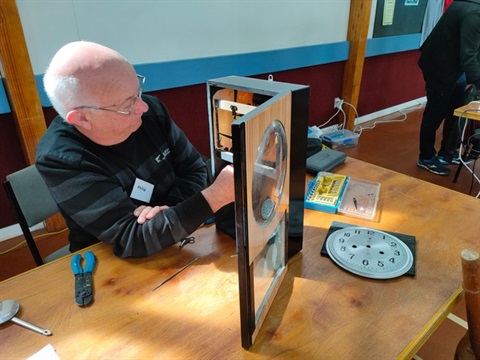 Man working on clock at the Upper Hutt Repair Cafe